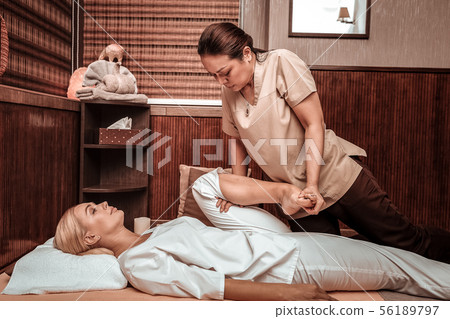 Relaxed woman getting her thai massage session. 56189797