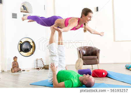 Healthy couple performing acroyoga Healthy couple performing acroyoga 56193257