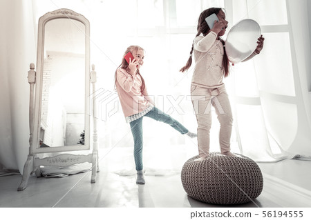 Two sisters playing on the bedroom floor in the morning Two sisters playing on the bedroom floor in the morning 56194555