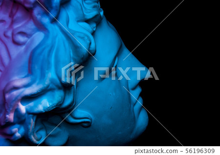 Gypsum copy of ancient statue Apollo head isolated on black background. Plaster sculpture man face. 56196309