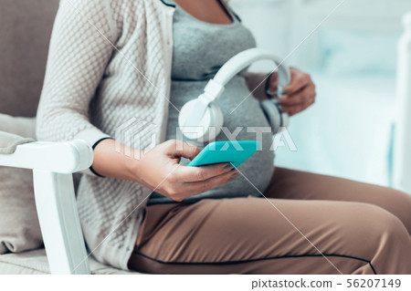 Relaxed female person looking at her gadget 56207149