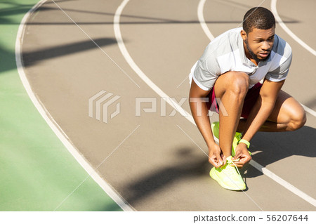 Calm fit African American male runner tying laces Calm fit African American male runner tying laces 56207644
