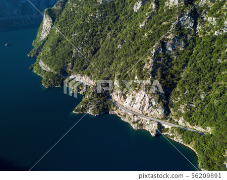 Aerial photo of a long winding road on Piva Lake in Montenegro 56209891