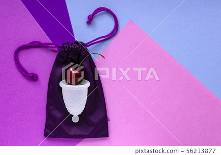 The concept of womens health. White menstrual Cup. The concept of womens health. White menstrual Cup. 56213877