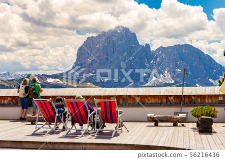 Italy. Dolomiti 19.06.2019: European people take selfies and admire the dolomites mountains scenery Italy. Dolomiti 19.06.2019: European people take selfies and admire the dolomites mountains scenery 56216436