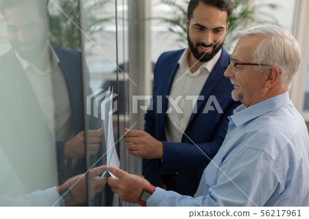 Kind grey-haired male demonstrating his business plan Kind grey-haired male demonstrating his business plan 56217961