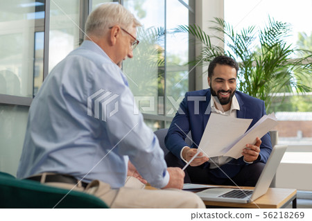 Positive delighted men working together in business center Positive delighted men working together in business center 56218269