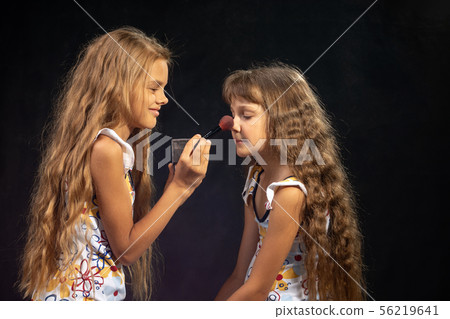 Older sister powders nose to younger sister Older sister powders nose to younger sister 56219641