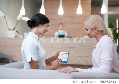 Woman fixing a meeting with her dentist. 56225243