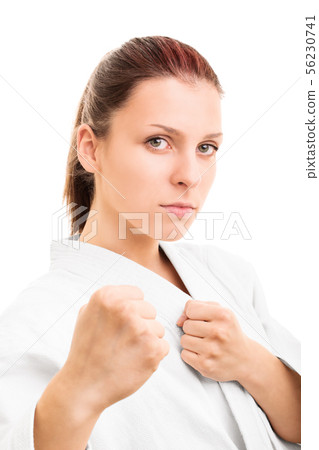 Young girl with the fists up isolated on white 56230741