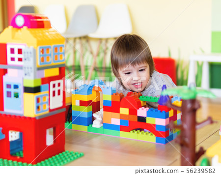 Toddler boy is playing with colorful constructor 56239582