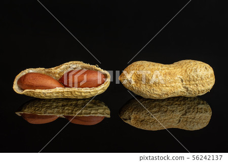 Yellow natural peanut isolated on black glass Yellow natural peanut isolated on black glass 56242137