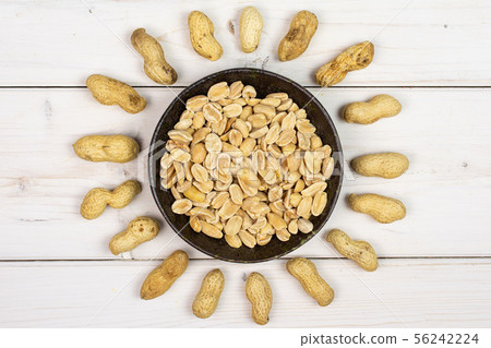 Yellow natural peanut on grey wood Yellow natural peanut on grey wood 56242224