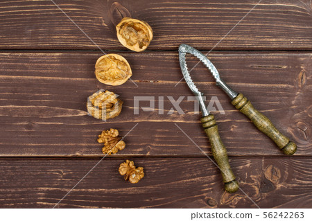 Ripe brown walnut on brown wood 56242263