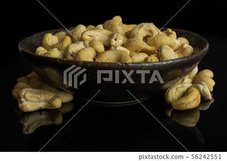 Raw unsalted cashew isolated on black glass 56242551