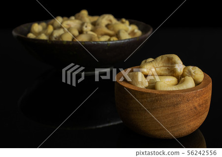 Raw unsalted cashew isolated on black glass 56242556