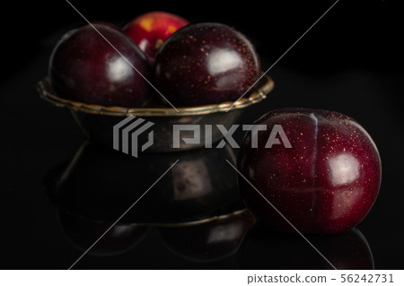 Ripe red plum isolated on black glass Ripe red plum isolated on black glass 56242731