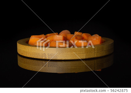 Orange baby carrot isolated on black glass 56242875