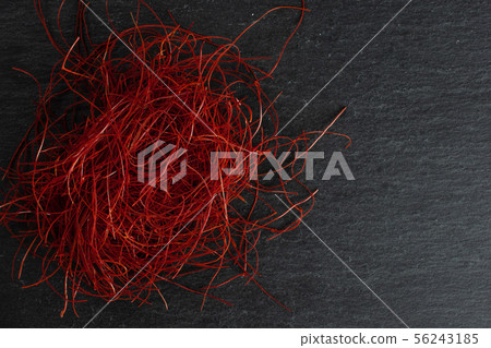 Red chili threads on grey stone Red chili threads on grey stone 56243185