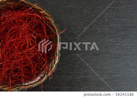 Red chili threads on grey stone Red chili threads on grey stone 56243186
