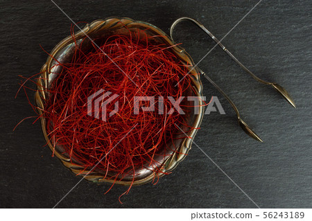 Red chili threads on grey stone Red chili threads on grey stone 56243189
