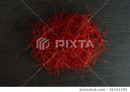 Red chili threads on grey stone Red chili threads on grey stone 56243190