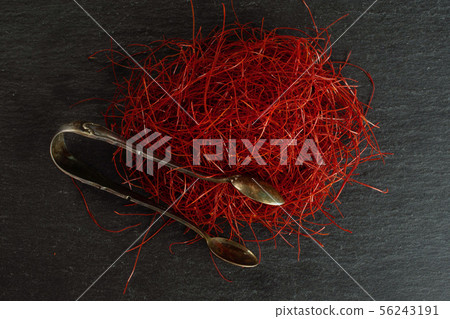 Red chili threads on grey stone 56243191
