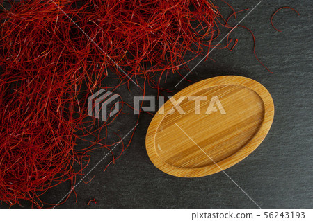 Red chili threads on grey stone Red chili threads on grey stone 56243193