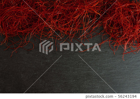 Red chili threads on grey stone Red chili threads on grey stone 56243194
