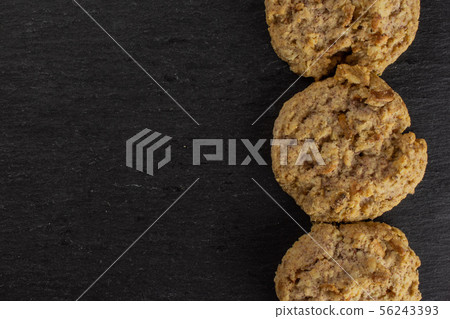 Oat crumble biscuit on grey stone Oat crumble biscuit on grey stone 56243393