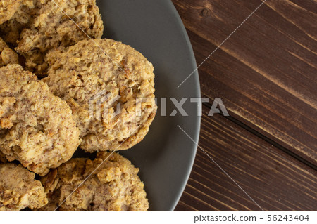 Oat crumble biscuit on brown wood Oat crumble biscuit on brown wood 56243404