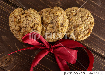 Oat crumble biscuit on brown wood Oat crumble biscuit on brown wood 56243412