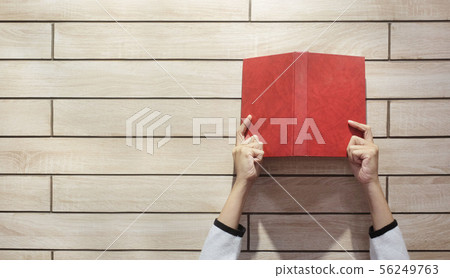 The hands of woman hold book The hands of woman hold book 56249763