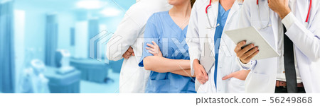 Doctor working in hospital with other doctors. 56249868