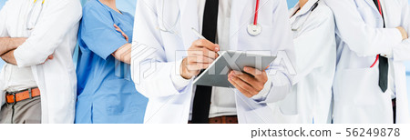 Doctor working in hospital with other doctors. 56249878