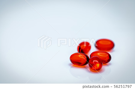 Red soft gel capsule pills isolated on white Red soft gel capsule pills isolated on white 56251797