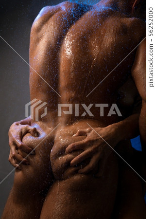 Hands grabbing at a naked man body cropped shot 56252000