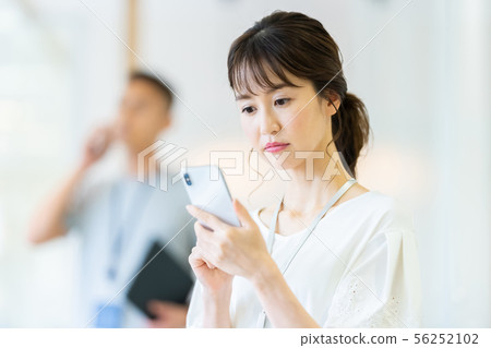 Business image of female employee talking on smartphone Business image of female employee talking on smartphone 56252102