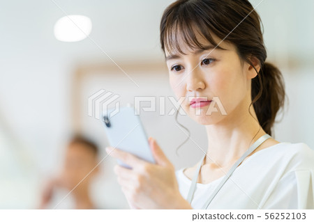 Business image of female employee talking on smartphone Business image of female employee talking on smartphone 56252103