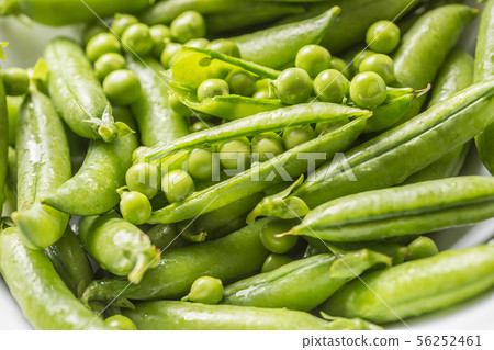 Fresh green pea seeds and pods - Close up Fresh green pea seeds and pods - Close up 56252461