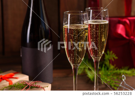Christmas holiday table with glasses and a bottle Christmas holiday table with glasses and a bottle 56253228