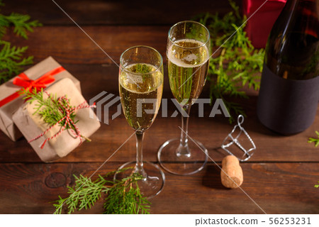 Christmas holiday table with glasses and a bottle Christmas holiday table with glasses and a bottle 56253231