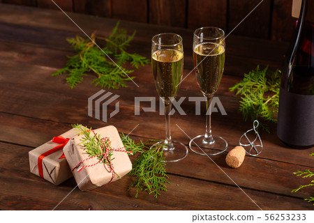 Christmas holiday table with glasses and a bottle Christmas holiday table with glasses and a bottle 56253233