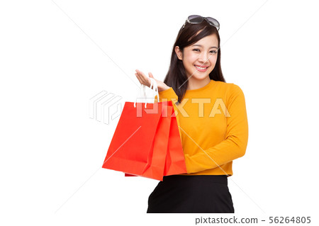 Portrait of a happy young woman holding shopping Portrait of a happy young woman holding shopping 56264805