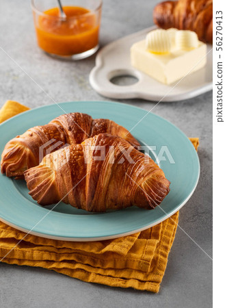 Delicious breakfast with fresh croissants and jam served with butter. 56270413