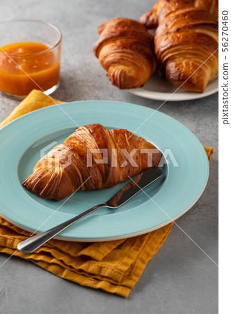 Delicious breakfast with fresh croissants and jam served with butter. 56270460