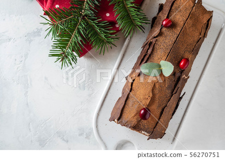 Bush de Noel Christmas Log Cake and New Year background. Copy space. Bush de Noel Christmas Log Cake and New Year background. Copy space. 56270751