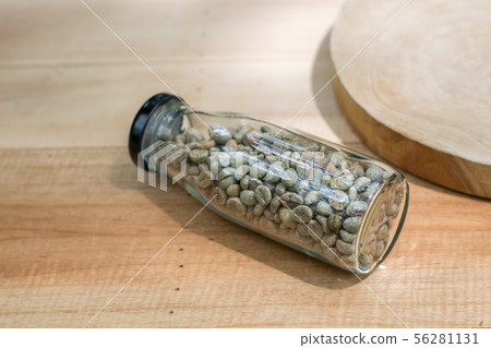 coffee beans in the bottle on wood table 56281131