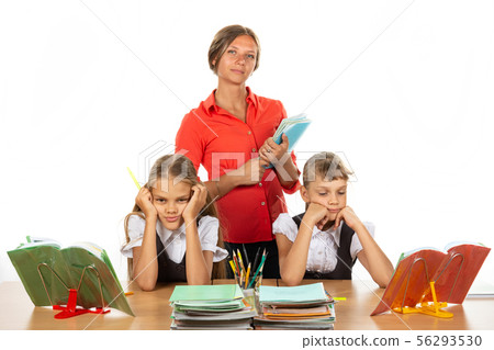 Bored schoolgirls at a desk, in the background a 56293530