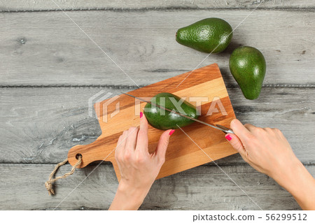 Tabletop view, woman hands holding chef knife, Tabletop view, woman hands holding chef knife, 56299512